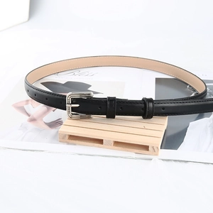 Classic black leather belt for women with a vintage silver square buckle on a magazine