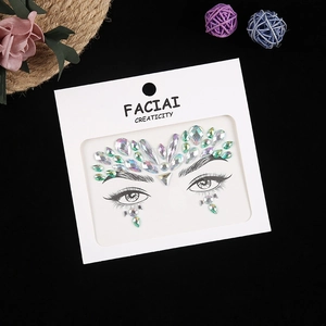 Macro view of colorful acrylic rhinestone face gems in creative decorative packaging