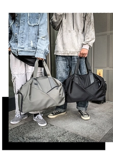 Gray and black travel bags for sports and fitness shown with models in a city street setting