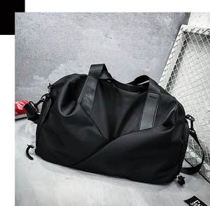 Close-up of durable black nylon travel bag with reinforced handles and brand logo patch