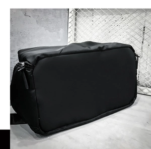 Macro shot of waterproof black travel bag surface with durable zipper and handles