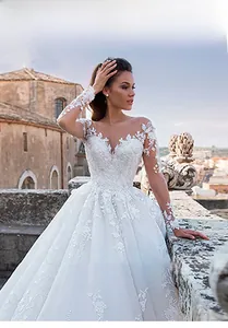 Exquisite detail of floral lace embroidery on long sleeves of an elegant white bridal gown