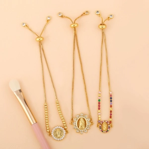 Adjustable gold Virgin Mary and Saint Benedict bracelets with sparkling zircon stones