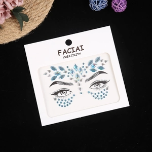 Detailed view of blue and iridescent rhinestone face jewels for music festival makeup