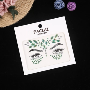 Macro shot of green and iridescent facial crystal stickers with teardrop rhinestones