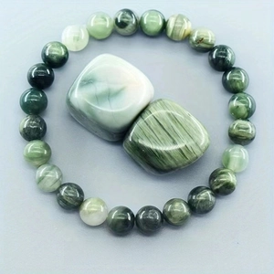 Macro shot of green straw hat gemstone beads bracelet with natural stone texture