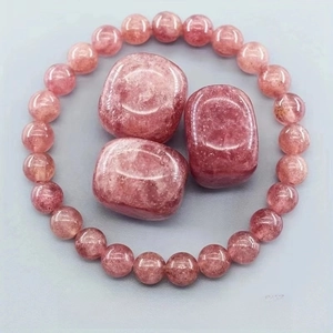 Detailed macro view of strawberry crystal beads and polished raw quartz stones