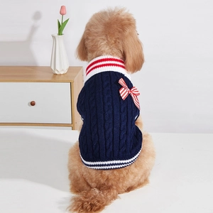 Navy blue dog knit sweater with red white stripes and a decorative bow on the back