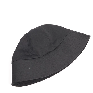 Detailed view of black canvas bucket hat showing firm texture and fine stitching on brim