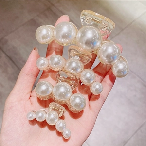 Three pearl hair claw clips in large, medium, and small sizes with shiny white pearls