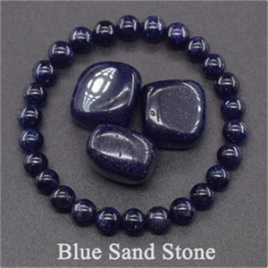 Detail of blue sand stone beaded stretch bracelet with polished sparkling raw stones