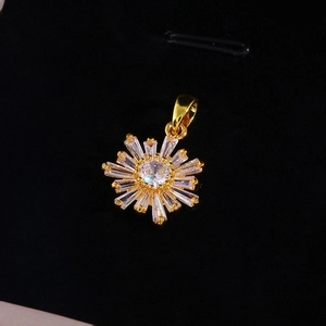 Golden sunflower pendant necklace with sparkling cubic zirconia on black velvet background