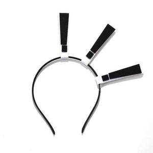 Detail view of a black Halloween headband featuring three black and white exclamation marks