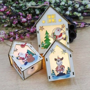 Close-up of glowing wooden Christmas house lanterns with Santa and reindeer motifs