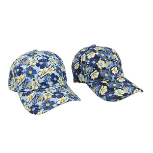Floral print baseball caps in light and dark blue patterns with curved brim design