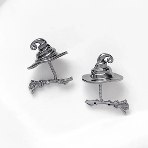 Detailed macro view of gunmetal black wizard hat and broom earrings with fine rhinestones
