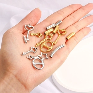 Assorted gold and silver stainless steel jewelry charms and connectors for DIY crafts