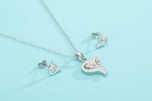 Detailed view of hollow fox jewelry set including necklace and studs on light blue background