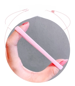 Detail of pink high-elastic nylon hair tie showing tight woven texture and stretchability
