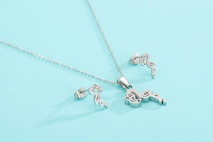 Close-up of stylish silver flamingo necklace and earrings set on light blue background
