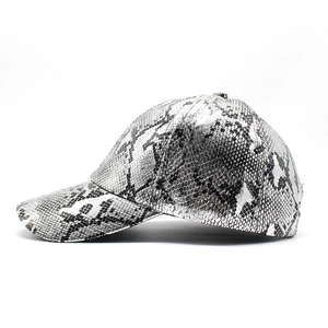 Detail view of snakeskin pattern on silver-black PU leather baseball cap surface