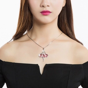 Rose gold ballerina pendant necklace featuring a sparkling pink crystal skirt on a model
