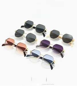 Octagonal metal sunglasses in multiple colors arranged in a clean studio display