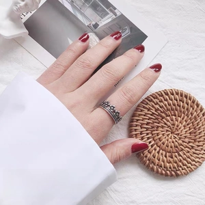 Close-up of vintage silver floral adjustable ring made of alloy worn by a female model
