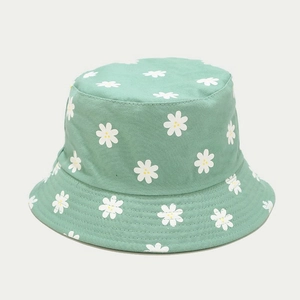 Detailed close-up of light green canvas bucket hat with white daisy floral patterns