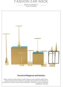 Detail of matte gold metal earring display stands with T-bar and geometric bases