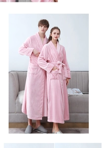 Detail of pink flannel robes featuring white piping, large pockets, and belted waist design