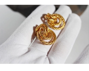 Detailed view of vintage gold twisted hoop earrings with elegant woven texture design
