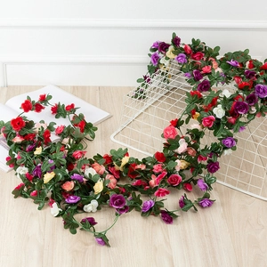 Detailed view of colorful artificial rose vines on a white grid for wall decoration