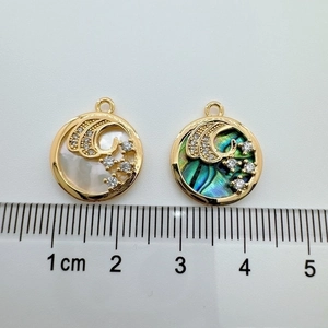 Detailed view of 18K gold plated seashell charms with ruler showing 1.8cm diameter size