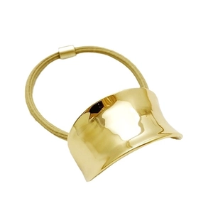 Minimalist gold alloy concave metal hair tie with beige elastic band on white background