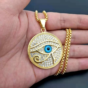 Gold plated Eye of Horus pendant necklace with blue eye and sparkling crystal accents