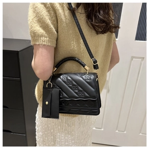 Black quilted PU leather handbag with woven handle and small coin purse charm