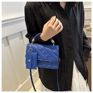 Blue textured top handle crossbody bag with matching coin purse and golden hardware