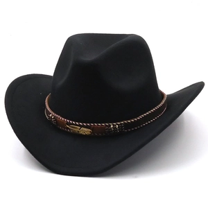 Detail of black wool felt cowboy hat with gold feather pin and beaded brown band