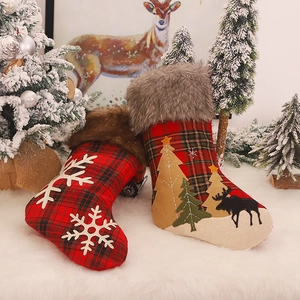 Red and black plaid Christmas stockings with white faux fur trim and snowflake applique