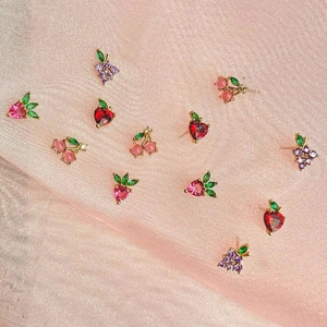 Close-up of fruit-shaped stud earrings featuring strawberry, cherry, and grape cubic zirconia