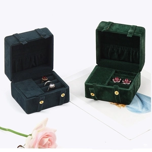 Detailed view of dark green velvet jewelry boxes with snap closure and ring slots