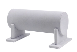Macro detail of a soft grey velvet cylindrical stand for organizing headbands and bracelets