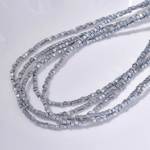 2mm rainbow hematite cube beads necklace with silver metallic luster on white background