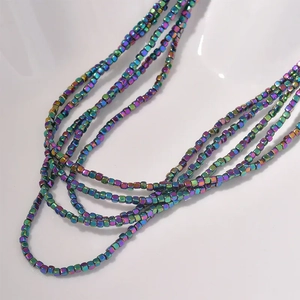 Macro detail of 2mm iridescent hematite cube beads for DIY jewelry making and crafts