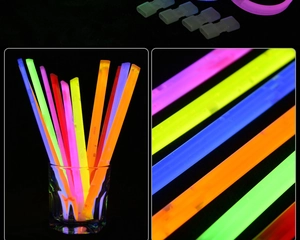 Macro view of colorful glowing sticks in dark glass and plastic connectors for bracelets