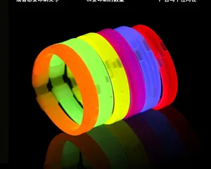 Vibrant glowing bracelets in six colors displayed on a black reflective background