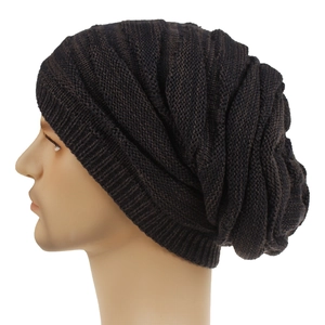Close-up of a slouchy dark brown knit beanie with textured vertical stripe patterns