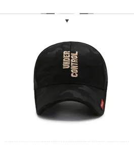 Close-up of 3D Under Control embroidery on black camouflage baseball cap with red tag