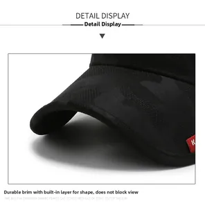 Macro detail of black camouflage baseball cap brim with sturdy stitching and red side label